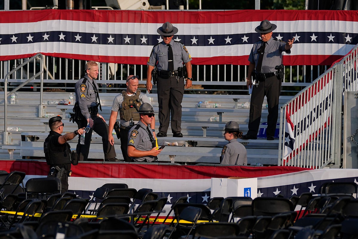 (AP Photo/Evan Vucci) : Law enforcement officers gather at the campaign rally site for Republican presidential candidate former President Donald Trump Saturday, July 13, 2024, in Butler, Pa. Trump's campaign said in a statement that the former president was "fine" after a shooting at his rally in Butler 